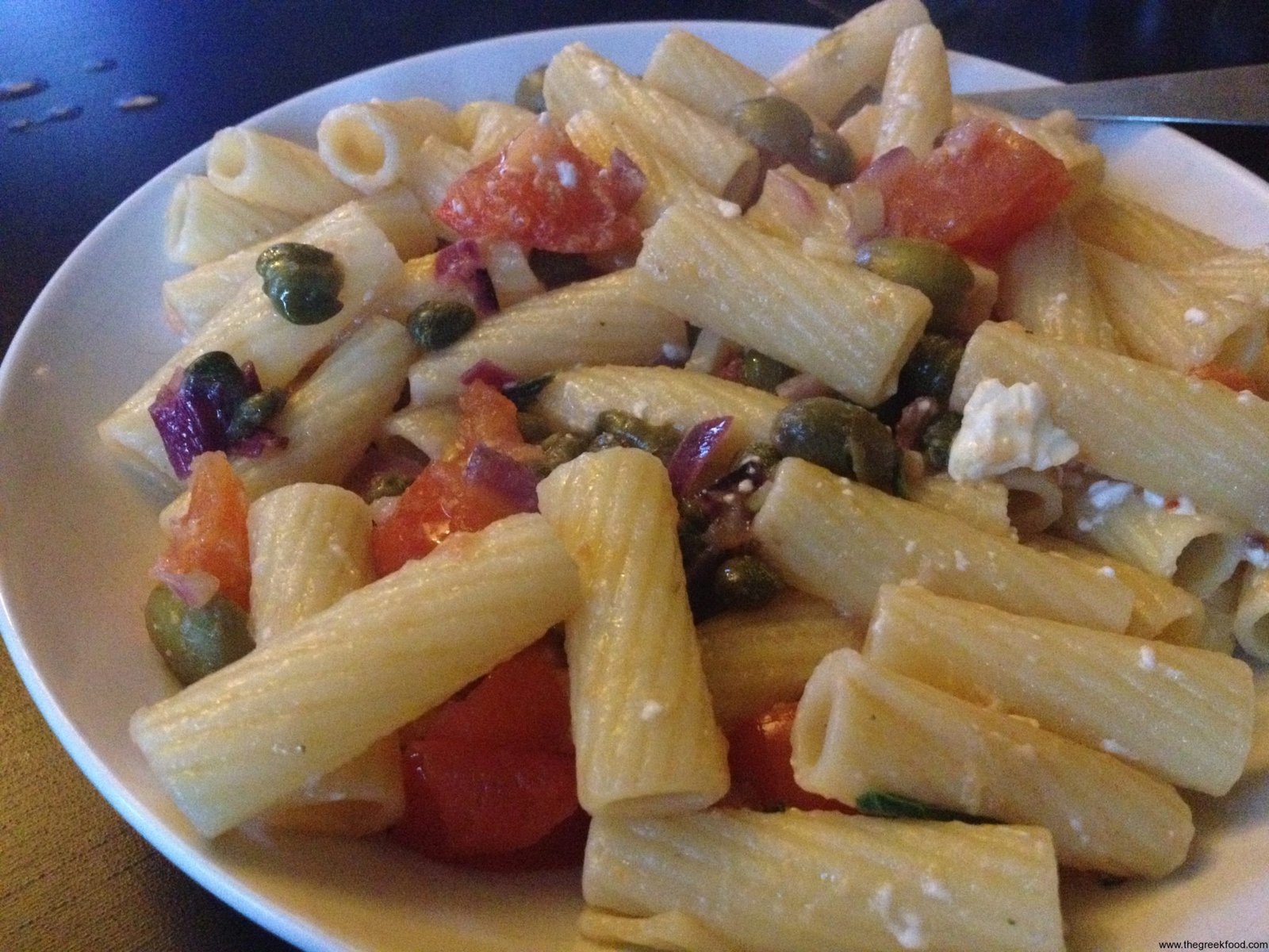 Pasta with feta cheese, tomato and capers