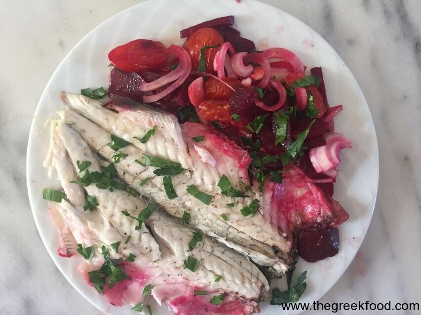 Cooking a bass fish with beetroots